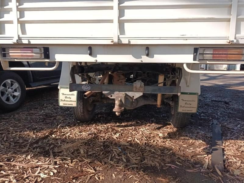 A White Truck is Parked on a Dirt Road— South West 4WD Wreckers In Brisbane, QLD