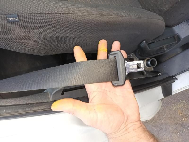 A Person is Holding a Seat Belt in Their Hand — South West 4WD Wreckers In Brisbane, QLD