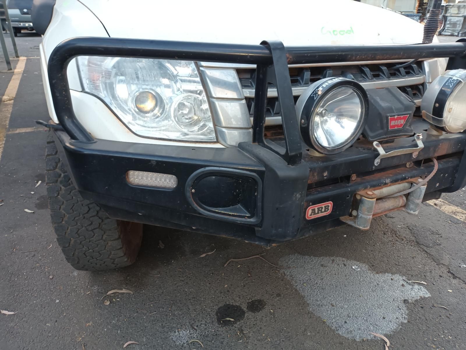 A White Suv With a Black Bumper is Parked on the Side of the Road — South West 4WD Wreckers In Brisbane, QLD