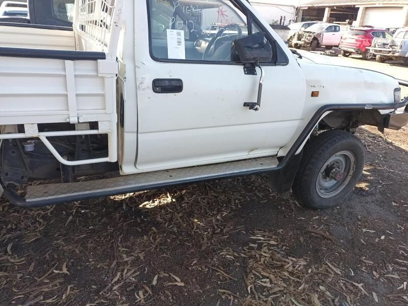 A White Truck With a Tag on the Door is Parked on the Ground — South West 4WD Wreckers In Brisbane, QLD