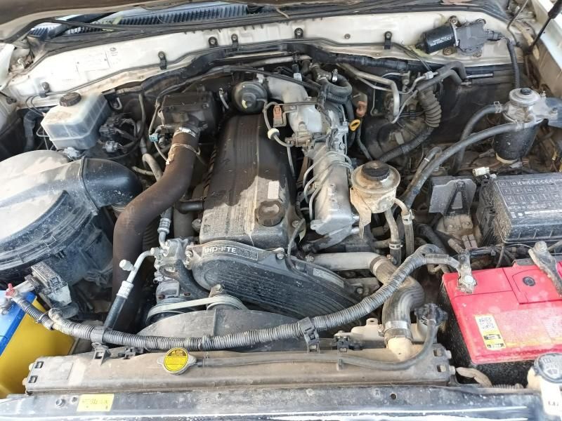 A Close Up of the Engine of a Car With a Red Battery — South West 4WD Wreckers In Harristown, QLD