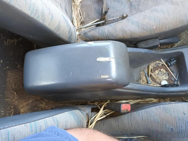 A Person is Sitting in a Car With a Broken Arm Rest — South West 4WD Wreckers In Brisbane, QLD