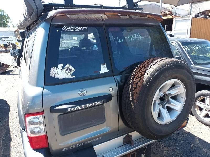 A Nissan Patrol is Parked in a Lot With Other Cars — South West 4WD Wreckers In Harristown, QLD