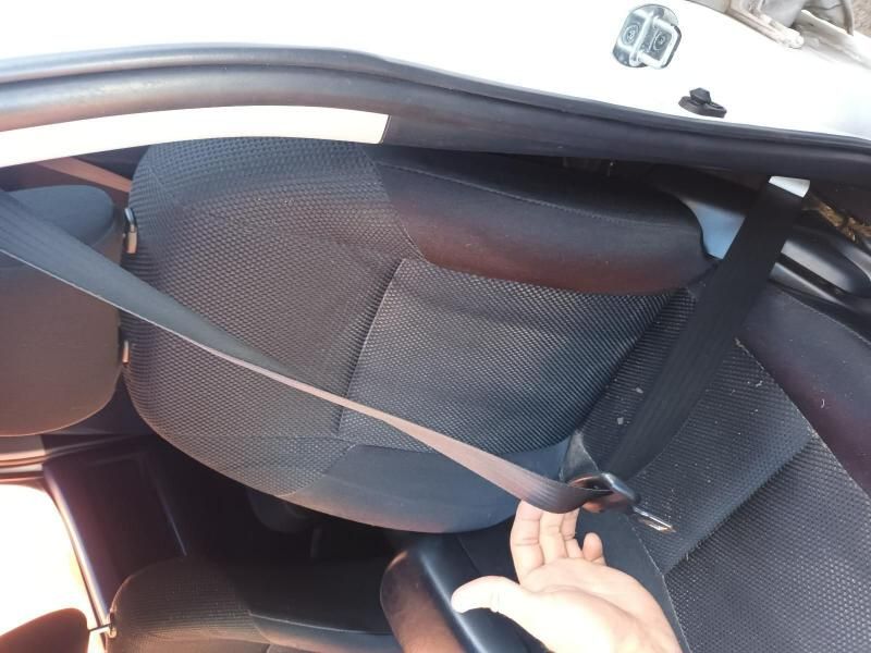 A Person is Putting on a Seat Belt in a Car — South West 4WD Wreckers In Harristown, QLD