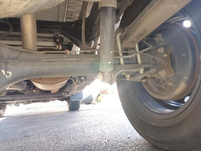 A Close Up of the Underside of a Car With a Black Tire — South West 4WD Wreckers In Harristown, QLD