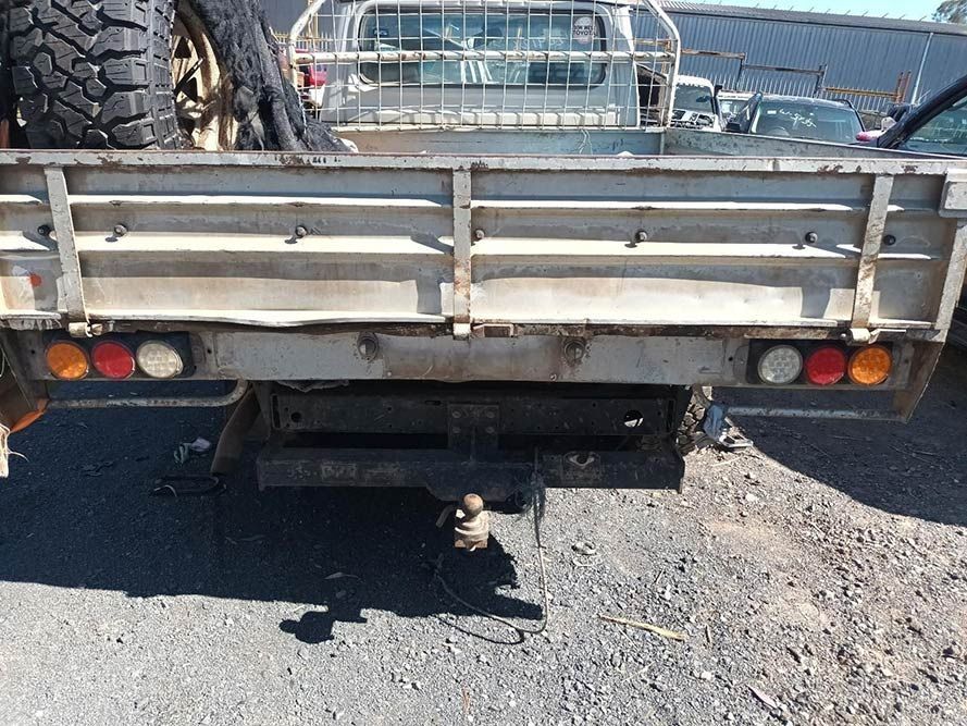 A Truck with a Trailer Attached to It is Parked in a Parking Lot — South West 4WD Wreckers in Harristown, QLD