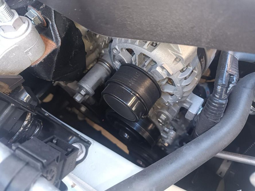 A Close Up of a Car Engine with a Belt on It — South West 4WD Wreckers in Harristown, QLD