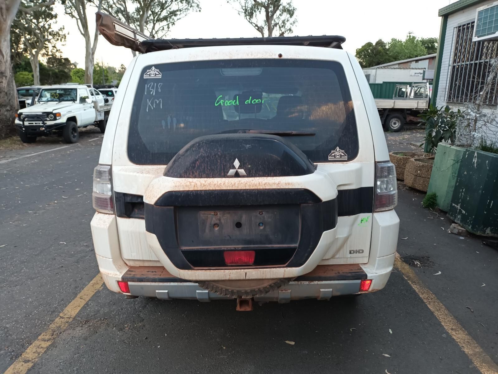 A White Mitsubishi Pajero is Parked in a Parking Lot — South West 4WD Wreckers In Brisbane, QLD