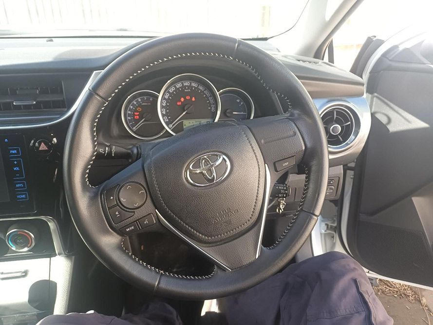 A Person is Sitting in the Driver's Seat of a Toyota Car — South West 4WD Wreckers in Harristown, QLD