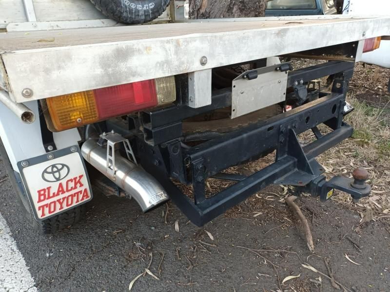 A Black Toyota Truck is Parked on the Side of the Road — South West 4WD Wreckers In Brisbane, QLD
