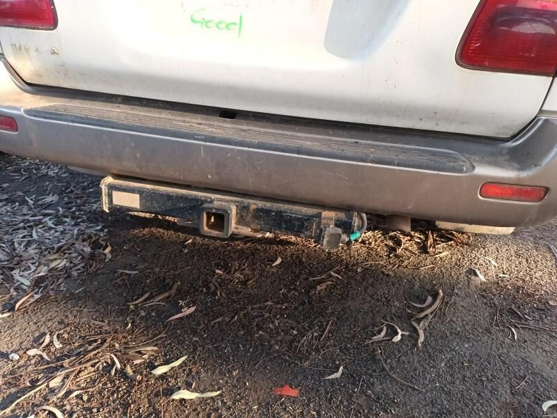 A White Car With a Trailer Hitch Attached to It — South West 4WD Wreckers In Harristown, QLD