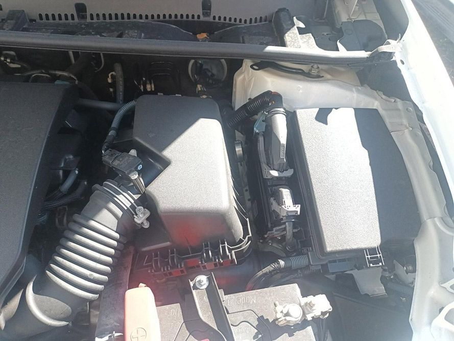 A Close Up of the Engine of a White Car — South West 4WD Wreckers in Harristown, QLD