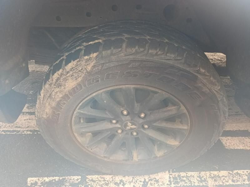 A Close Up of a Tire on a Car in a Parking Lot — South West 4WD Wreckers In Brisbane, QLD