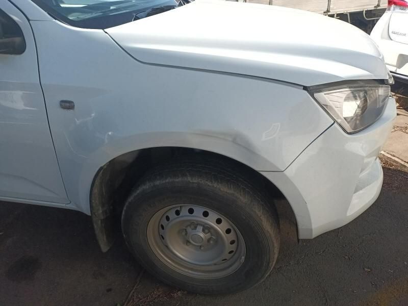 A White Truck With a Damaged Fender is Parked on the Side of the Road — South West 4WD Wreckers In Harristown, QLD