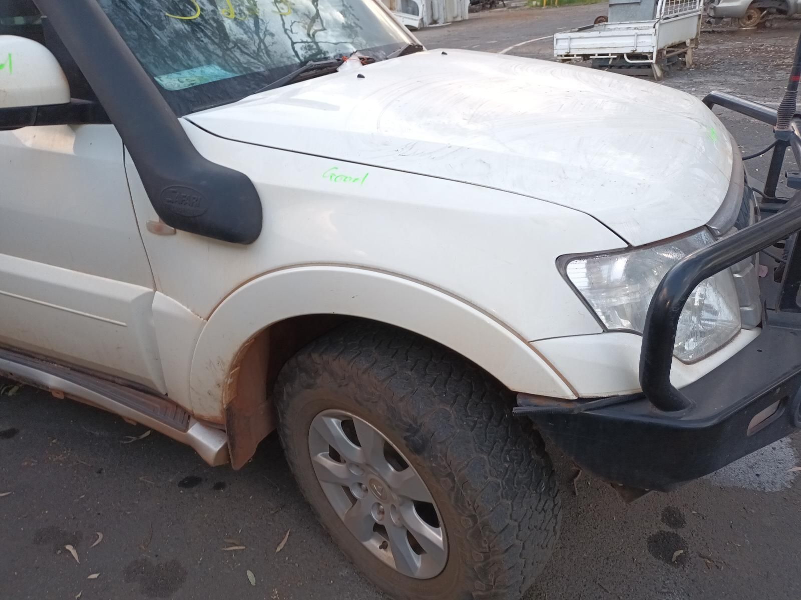 A White Suv With a Snorkel on the Hood is Parked on the Side of the Road — South West 4WD Wreckers In Brisbane, QLD
