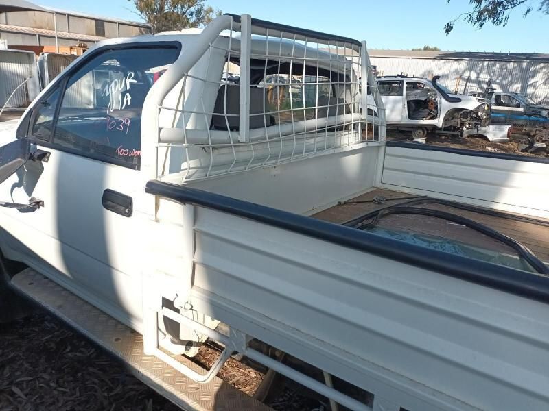 A White Truck With a Cage on the Back of It — South West 4WD Wreckers In Brisbane, QLD