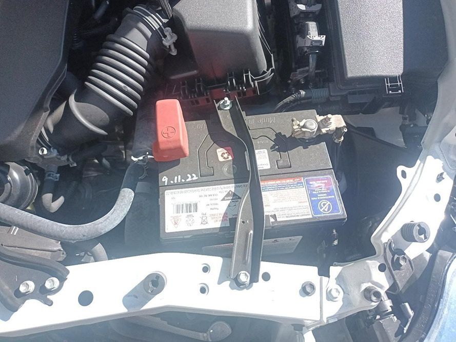 A Car Battery is Sitting Under the Hood of a Car — South West 4WD Wreckers in Harristown, QLD