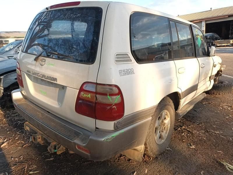 A White Land Cruiser is Sitting in a Parking Lot — South West 4WD Wreckers In Harristown, QLD
