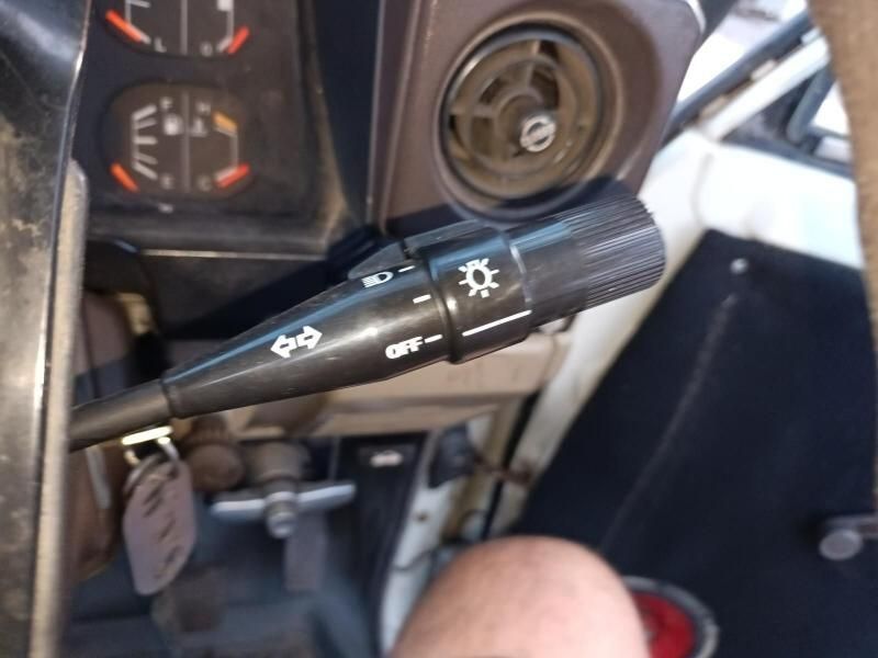 A Person is Holding a Switch in a Car That Has the Word Off on It — South West 4WD Wreckers In Brisbane, QLD