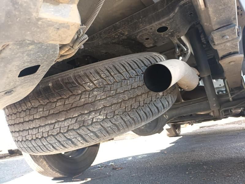 A Car With a Tire and Exhaust Pipe Underneath It — South West 4WD Wreckers In Harristown, QLD