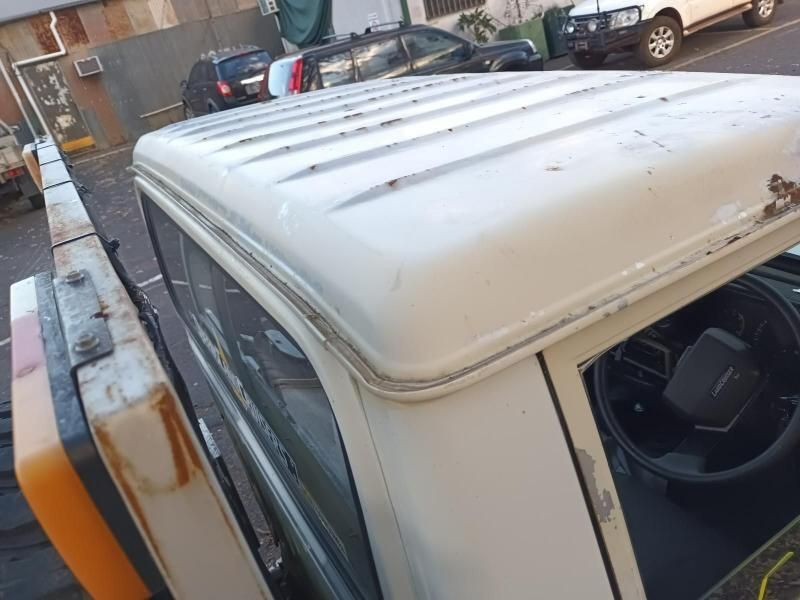 The Roof of a White Truck is Sitting on the Side of the Road — South West 4WD Wreckers In Brisbane, QLD