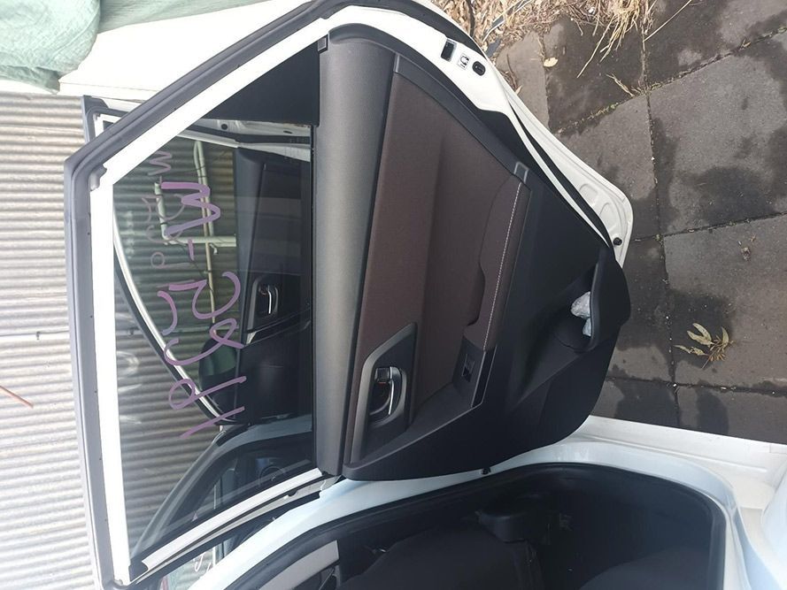 The Back Door of a White Car is Open — South West 4WD Wreckers in Harristown, QLD