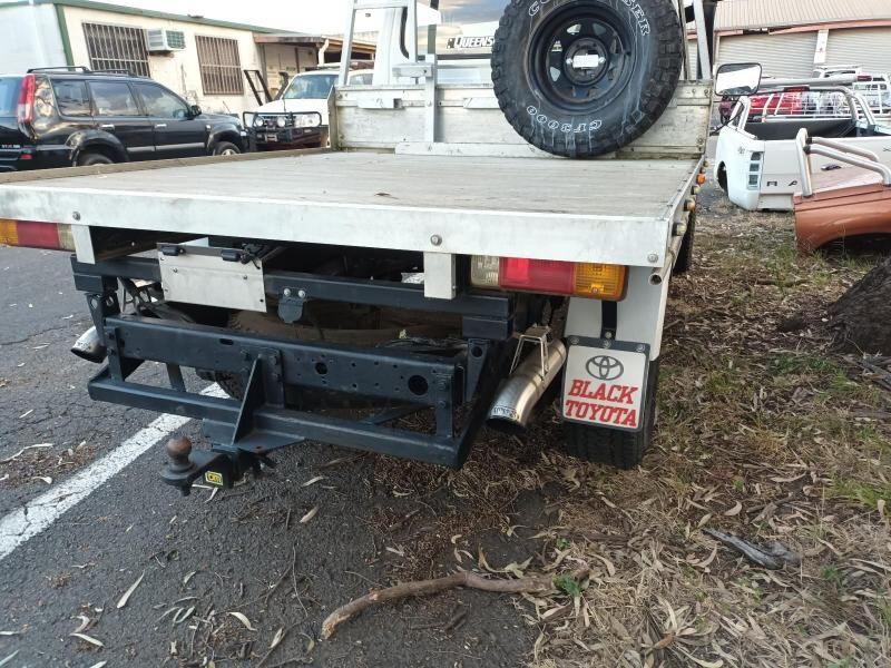 A Black Toyota Truck is Parked on the Side of the Road — South West 4WD Wreckers In Brisbane, QLD