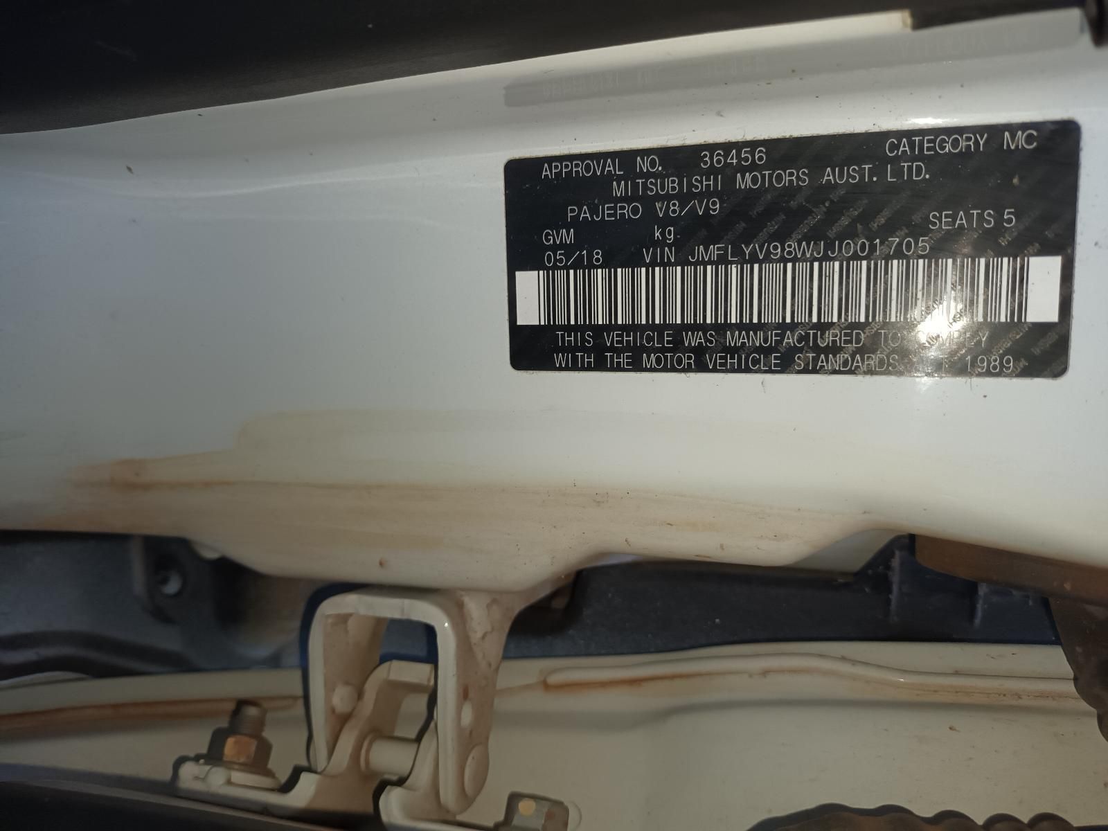 A White Car With a License Plate That Says Mitsubishi Motors Australia — South West 4WD Wreckers In Brisbane, QLD