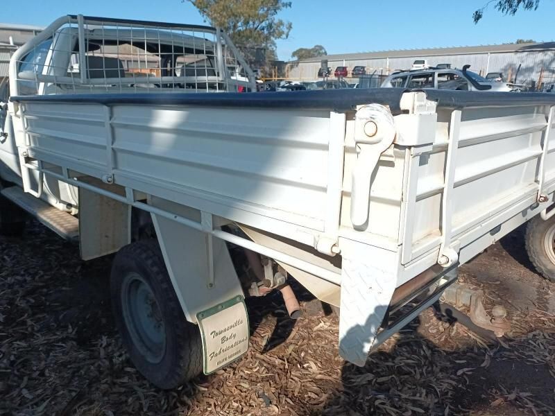 A White Truck is Parked on the Ground in a Parking Lot — South West 4WD Wreckers In Brisbane, QLD