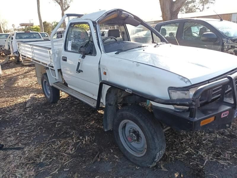 A White Truck With a Broken Roof is Parked in a Lot — South West 4WD Wreckers In Brisbane, QLD