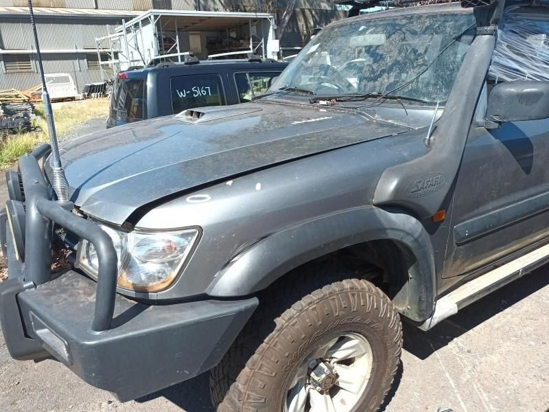 A Gray Truck With a Broken Hood is Parked on the Side of the Road — South West 4WD Wreckers In Harristown, QLD