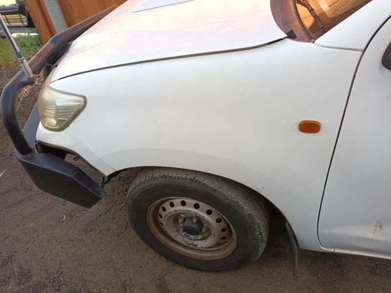 A White Car With a Black Bumper is Parked on a Dirt Road — South West 4WD Wreckers In Harristown, QLD