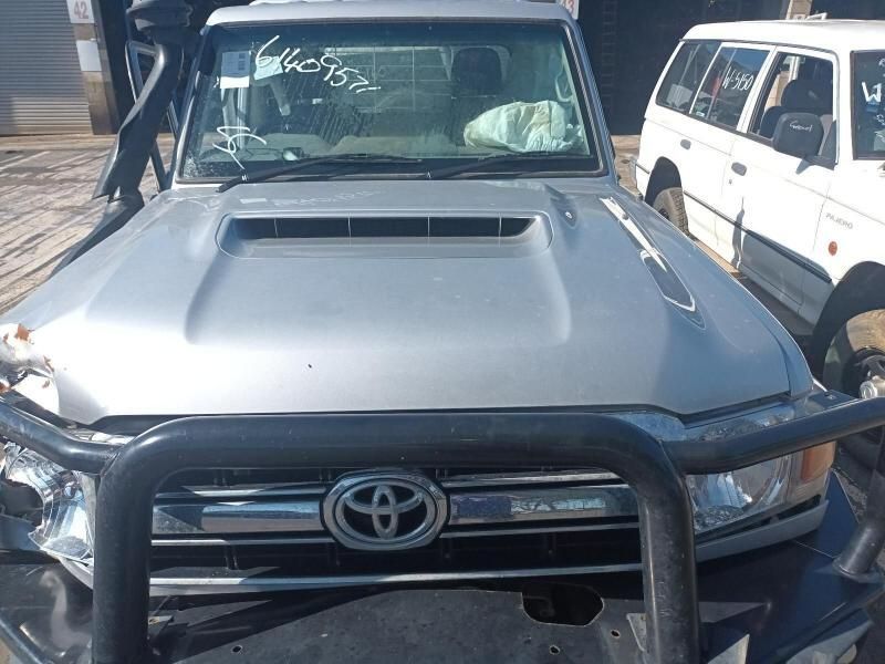 A Silver Toyota Truck is Parked Next to a White Van — South West 4WD Wreckers In Harristown, QLD
