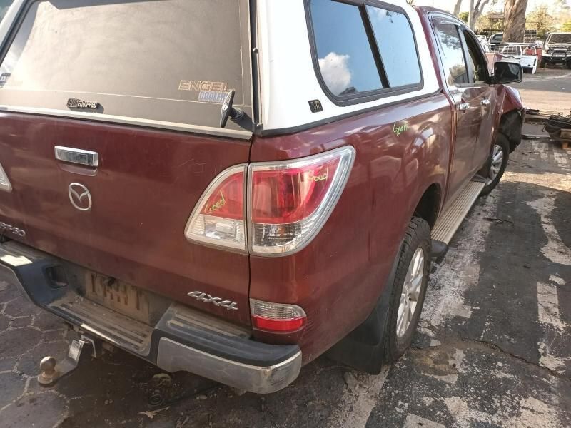 A Red Truck With a White Canopy is Parked in a Parking Lot — South West 4WD Wreckers In Harristown, QLD
