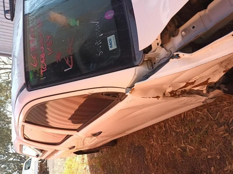 A White Car is Sitting on the Ground With the Door Open — South West 4WD Wreckers In Harristown, QLD