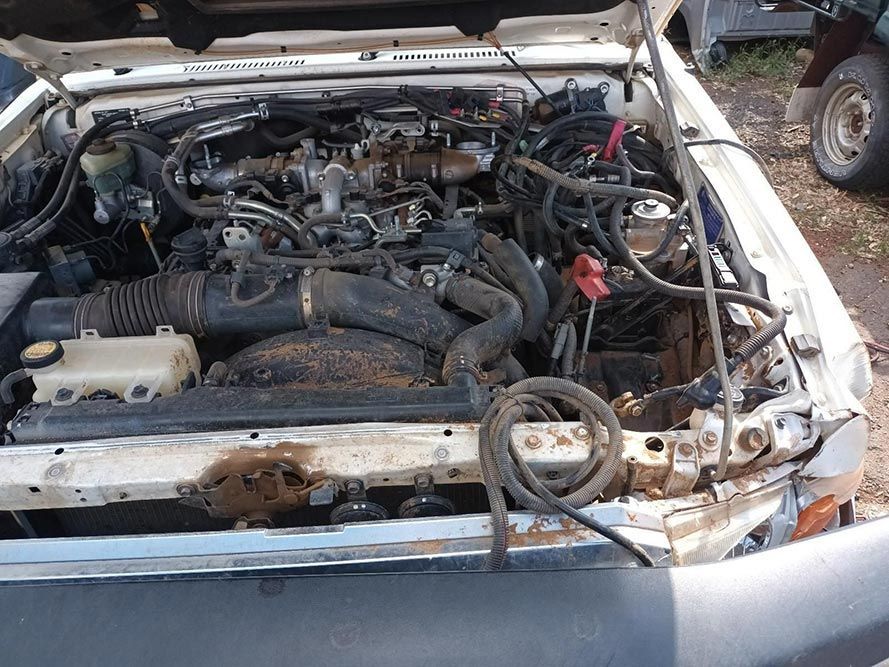 A White Car with the Hood Up and the Engine Exposed — South West 4WD Wreckers In Brisbane, QLD