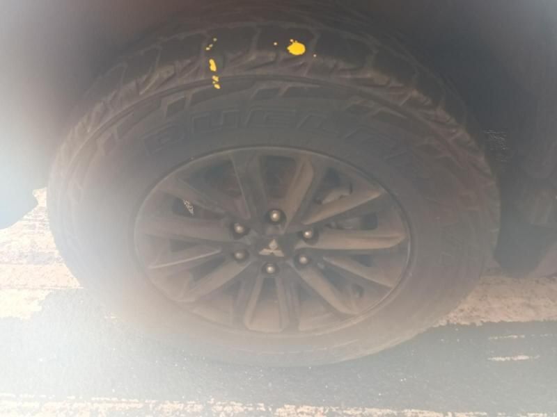A Close Up of a Tire on a Car in a Parking Lot — South West 4WD Wreckers In Brisbane, QLD