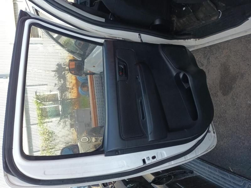 The Back Door of a White Car is Open — South West 4WD Wreckers In Harristown, QLD