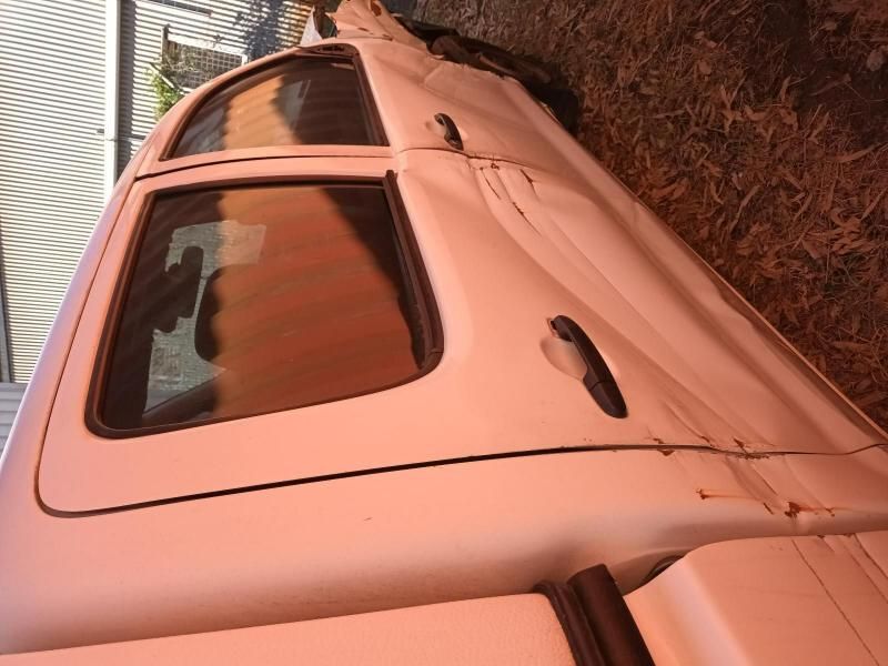 A White Truck is Parked on the Ground With the Door Open — South West 4WD Wreckers In Harristown, QLD