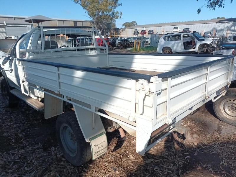 A White Truck With a Flat Bed is Parked in a Lot — South West 4WD Wreckers In Brisbane, QLD