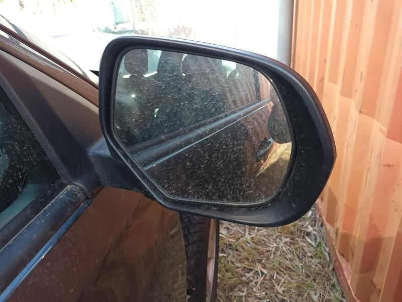 A Side View Mirror on a Car With a Wooden Fence in the Background — South West 4WD Wreckers In Harristown, QLD