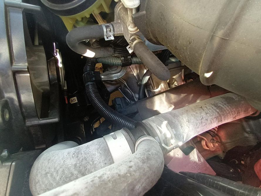 A Close Up of a Car Engine with a Hose Attached to It — South West 4WD Wreckers in Harristown, QLD