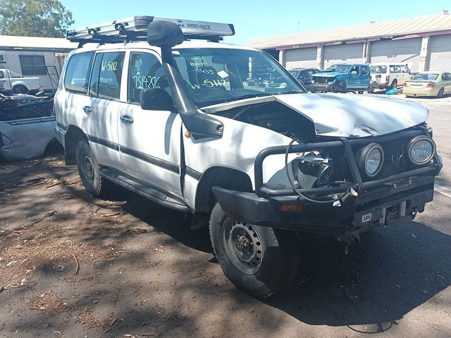 A White Suv with the Hood Up is Parked in a Parking Lot — South West 4WD Wreckers in Harristown, QLD 
