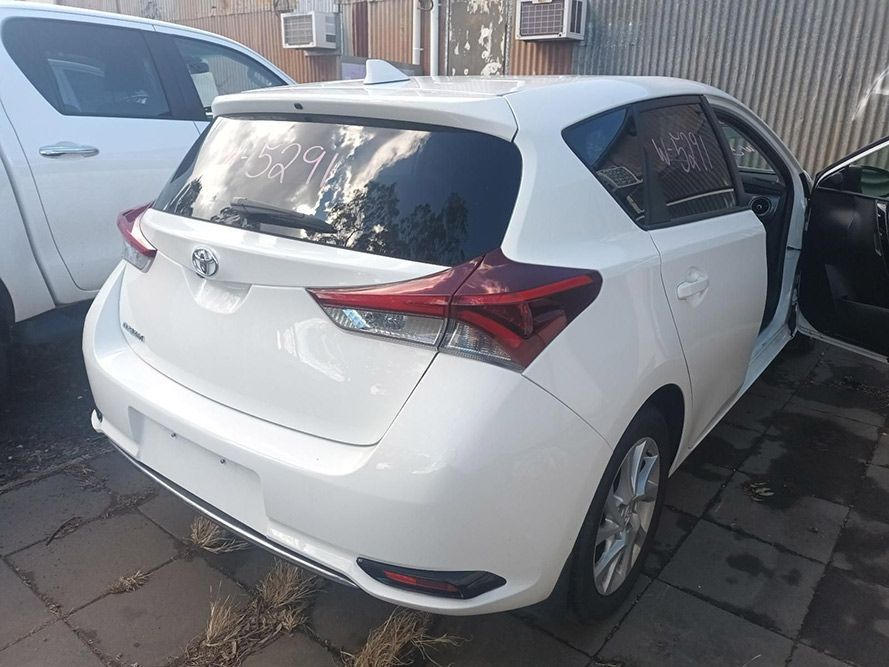 A White Toyota Auris Hatchback is Parked in Front of a Building — South West 4WD Wreckers in Harristown, QLD
