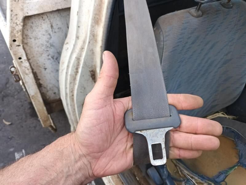 A Person is Holding a Seat Belt in Their Hand — South West 4WD Wreckers In Harristown, QLD