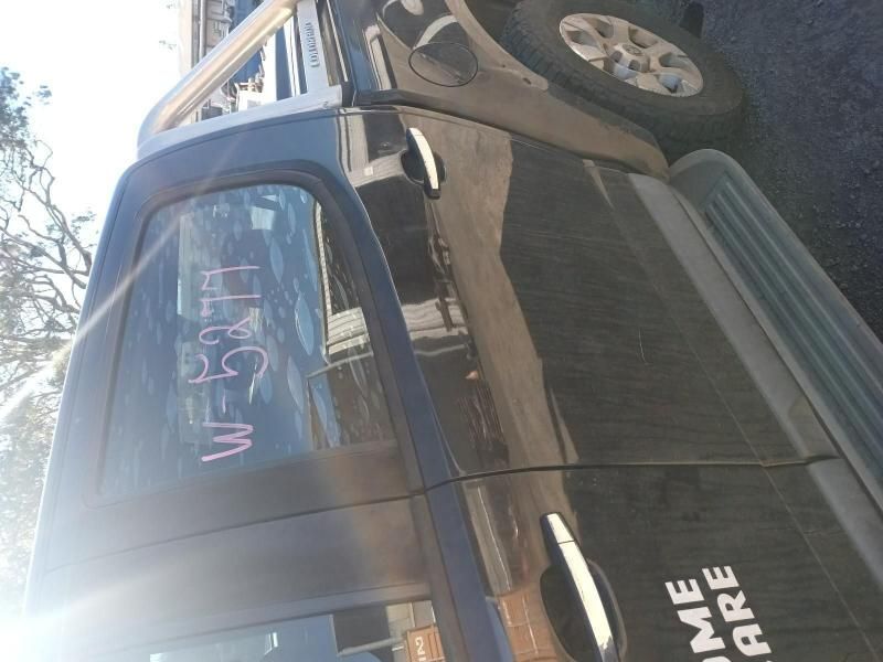 A Black Truck With a Sticker on the Door That Says