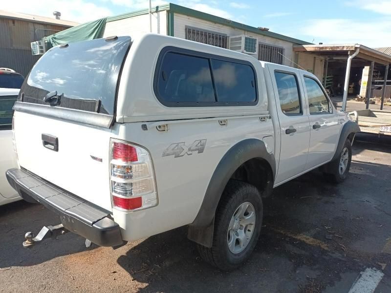 A White Truck With a Canopy is Parked in a Parking Lot — South West 4WD Wreckers In Harristown, QLD