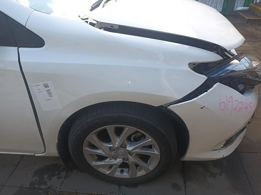 A White Car with a Damaged Front Bumper is Parked on the Side of the Road — South West 4WD Wreckers in Harristown, QLD