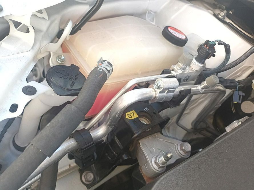 A Close Up of the Underside of a Car with a Water Tank and Hose — South West 4WD Wreckers in Harristown, QLD