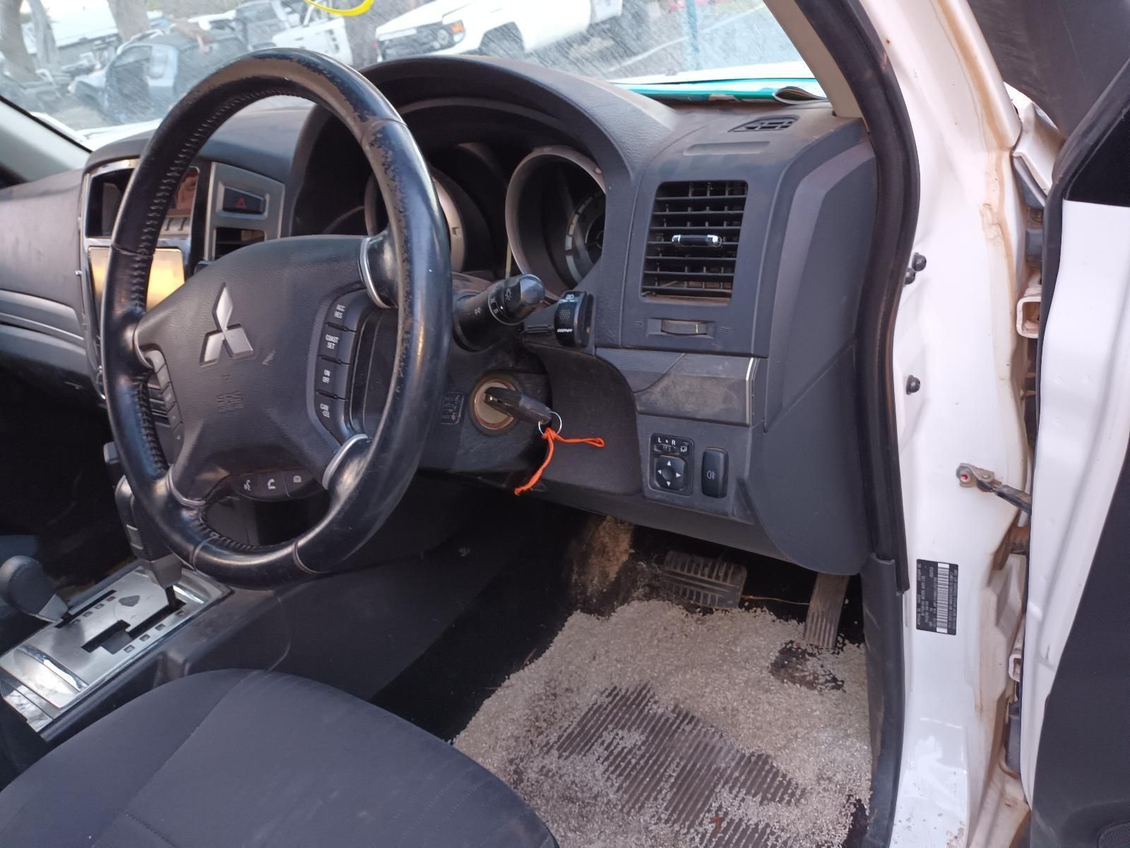 The Inside of a White Mitsubishi Car With the Door Open — South West 4WD Wreckers In Brisbane, QLD
